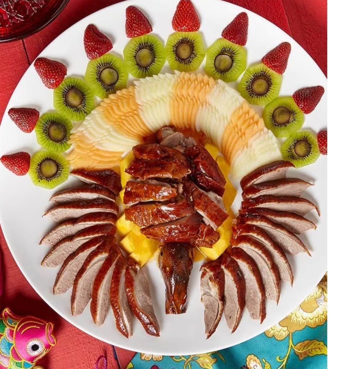 Roast goose served with a decorative fruit presentation